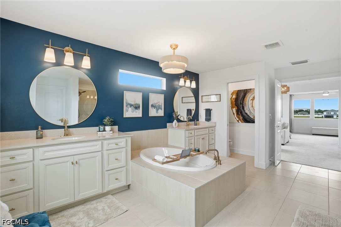 15572 Northridge Road Punta Gorda, FL 33982 - Photo 33 of 48 a spacious bathroom with a double vanity sink and a mirror