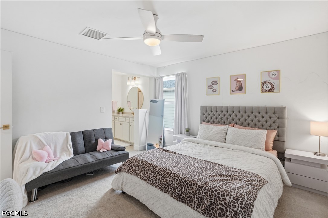 15572 Northridge Road Punta Gorda, FL 33982 - Photo 39 of 48 a spacious bedroom with a bed and a couch