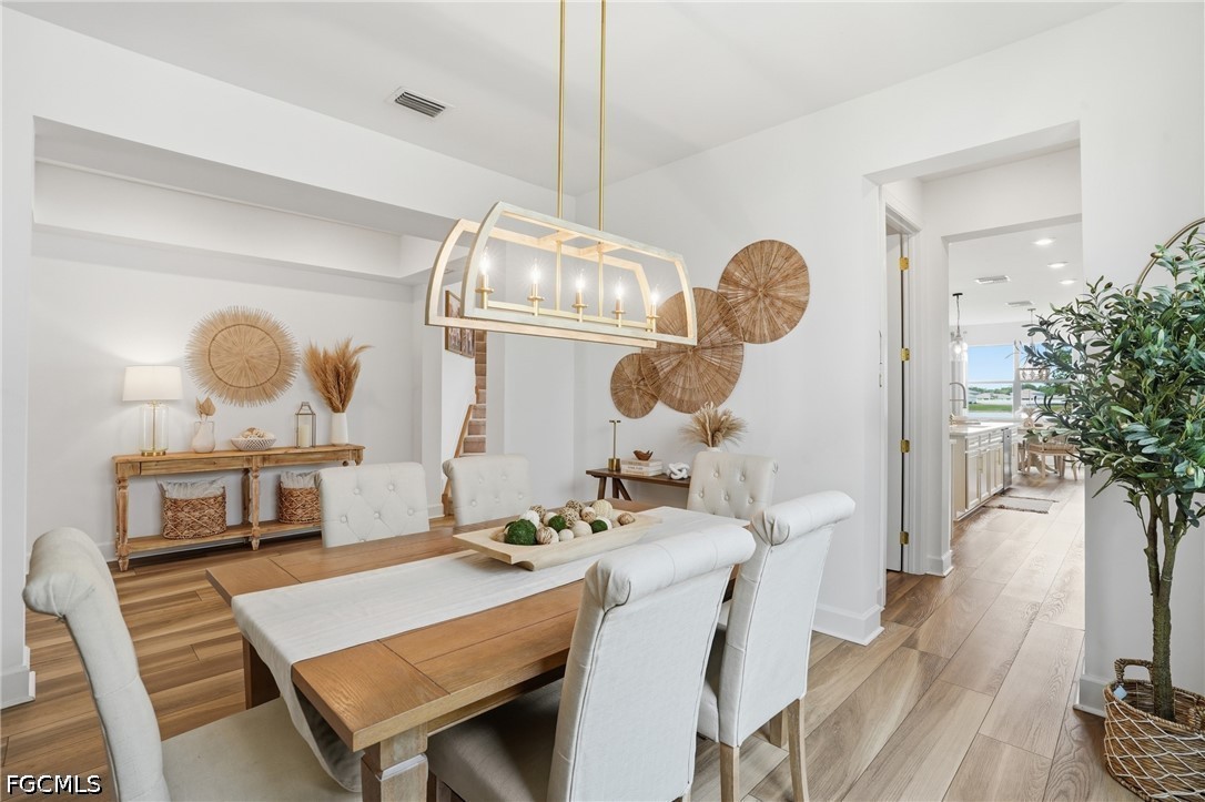 15572 Northridge Road Punta Gorda, FL 33982 - Photo 8 of 48 a dining room with furniture and wooden floor