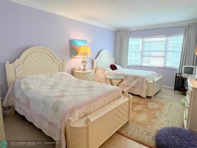 a bedroom with bed and window