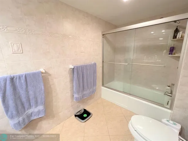 a bathroom with a bathtub and toilet