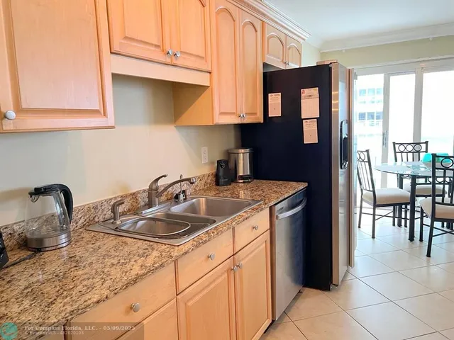 a kitchen with a sink cabinets and a window
