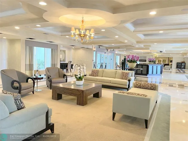 a living room with fireplace furniture and a chandelier