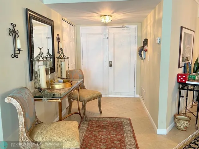 a living room with furniture a rug and a chandelier
