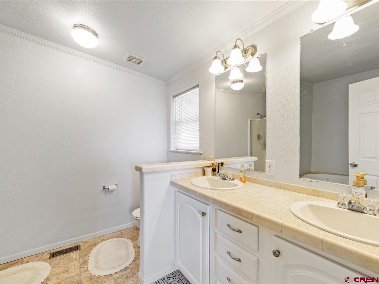 1857 Sego Lane Delta, CO 81416 - Photo 20 of 34 a bathroom with a granite countertop sink mirror and toilet