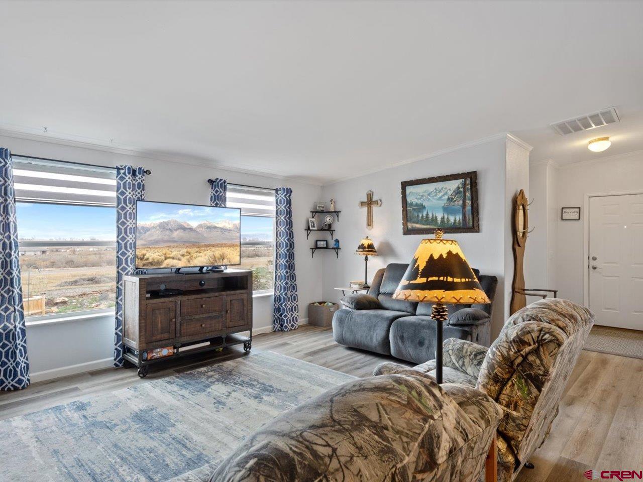 1857 Sego Lane Delta, CO 81416 - Photo 6 of 34 a bedroom with furniture and a flat screen tv