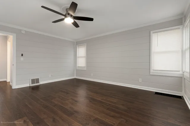 wooden floor in an empty room with a window