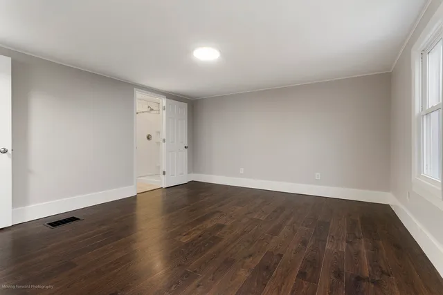 a view of an empty room and wooden floor