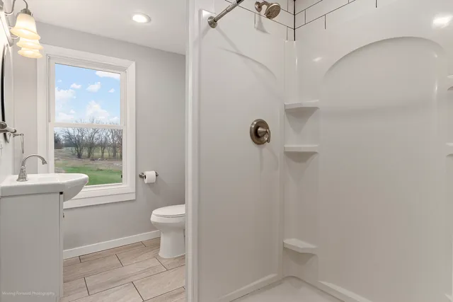 a bathroom with a toilet sink and shower