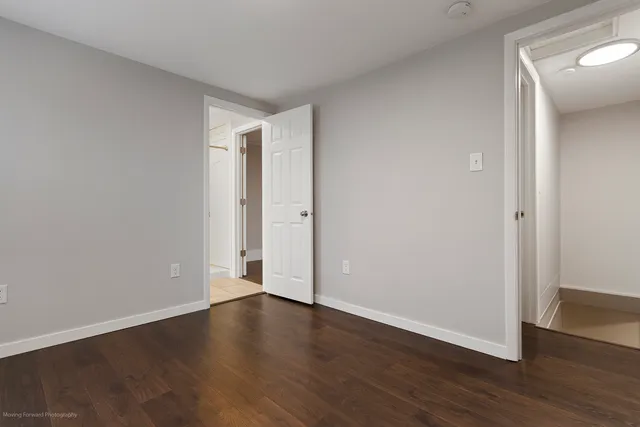 a view of an empty room with wooden floor