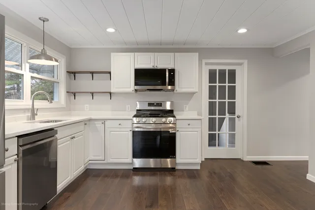 a kitchen with stainless steel appliances granite countertop a stove and a sink