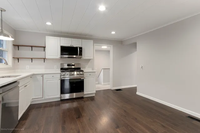 a kitchen with a sink and a stove top oven