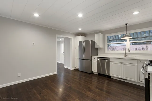 a kitchen with stainless steel appliances a refrigerator sink and microwave