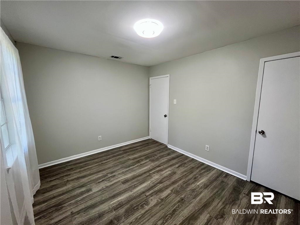 8636 Boe Road Irvington, AL 36544 - Photo 20 of 22 Unfurnished room with dark wood finished floors and baseboards