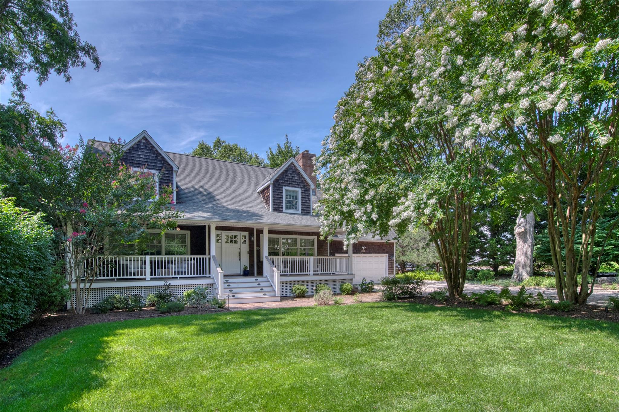 a front view of a house with a garden