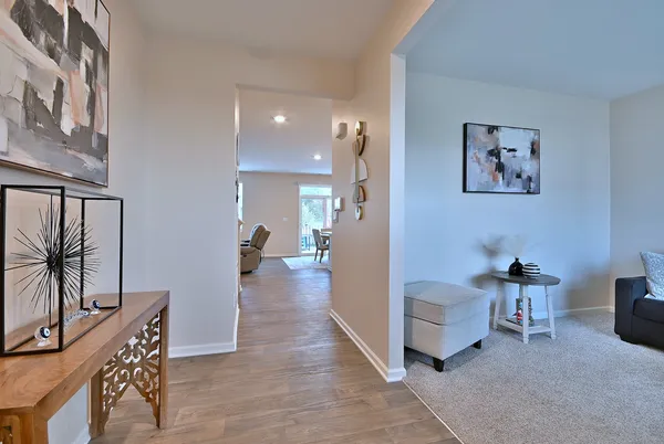 a living room with furniture and a painting on the wall