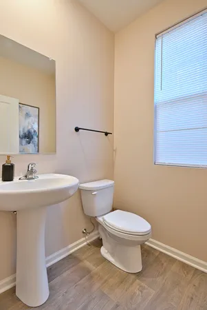 a bathroom with a sink a toilet and mirror