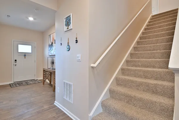 a view of entryway and hall with wooden floor