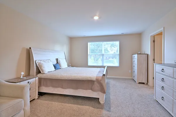 a bedroom with a bed and a dresser