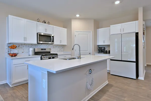 a kitchen with appliances a sink cabinets and a counter top space