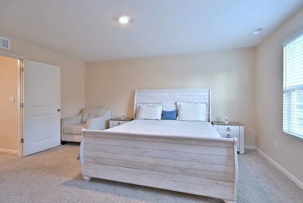 a bedroom with a bed and window