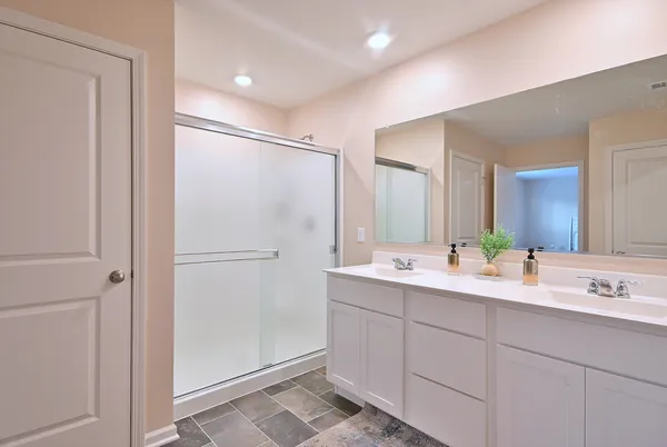 a bathroom with a double vanity sink mirror and double