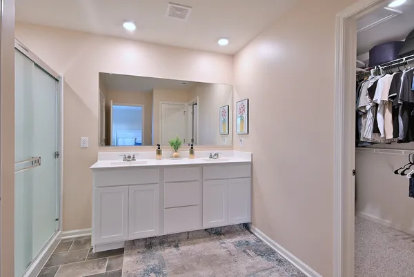 a bathroom with a double vanity sink and a mirror