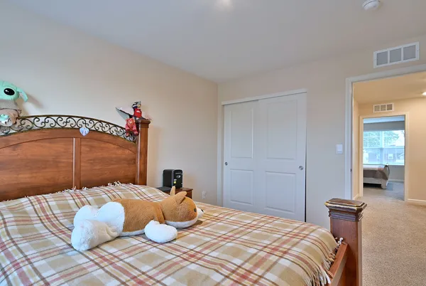a bedroom with a bed and a chandelier