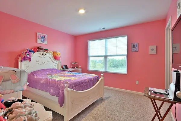 a bed room with a bed and a window