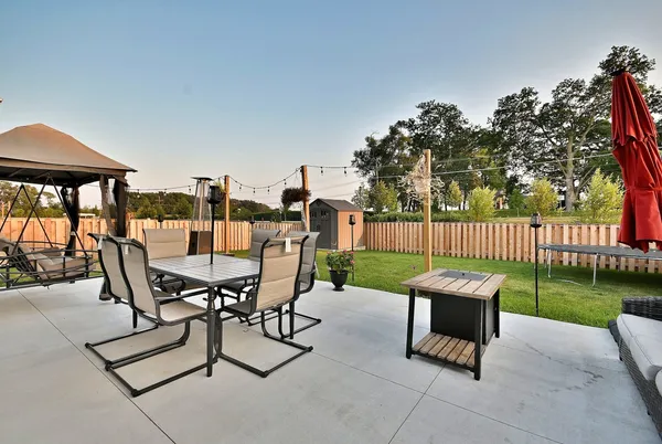 a view of a patio with a table and chairs