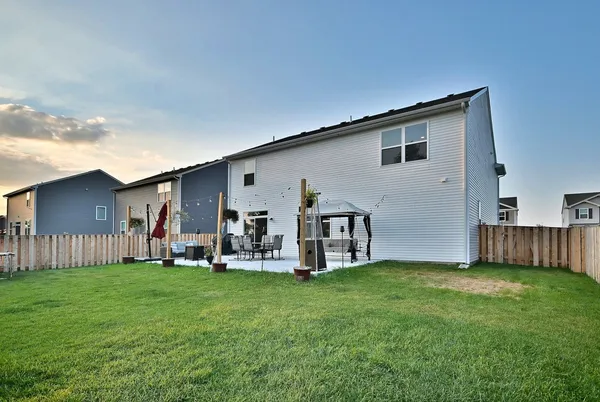 a view of a house with backyard and porch