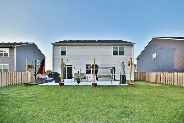a view of a house with backyard and porch
