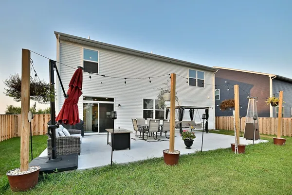 a front view of house with yard and outdoor seating