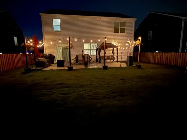 a group of people sitting in a yard