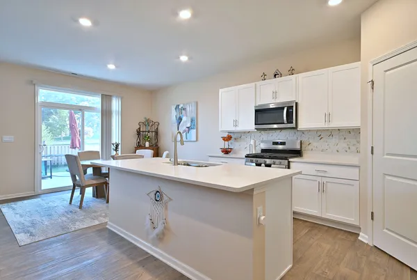 a kitchen with a sink cabinets and wooden floor