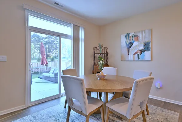 a view of a dining room with furniture large window and wooden floor