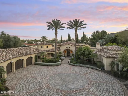 a view of a house with a yard and potted plants