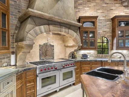 a kitchen with stainless steel appliances granite countertop a sink and cabinets
