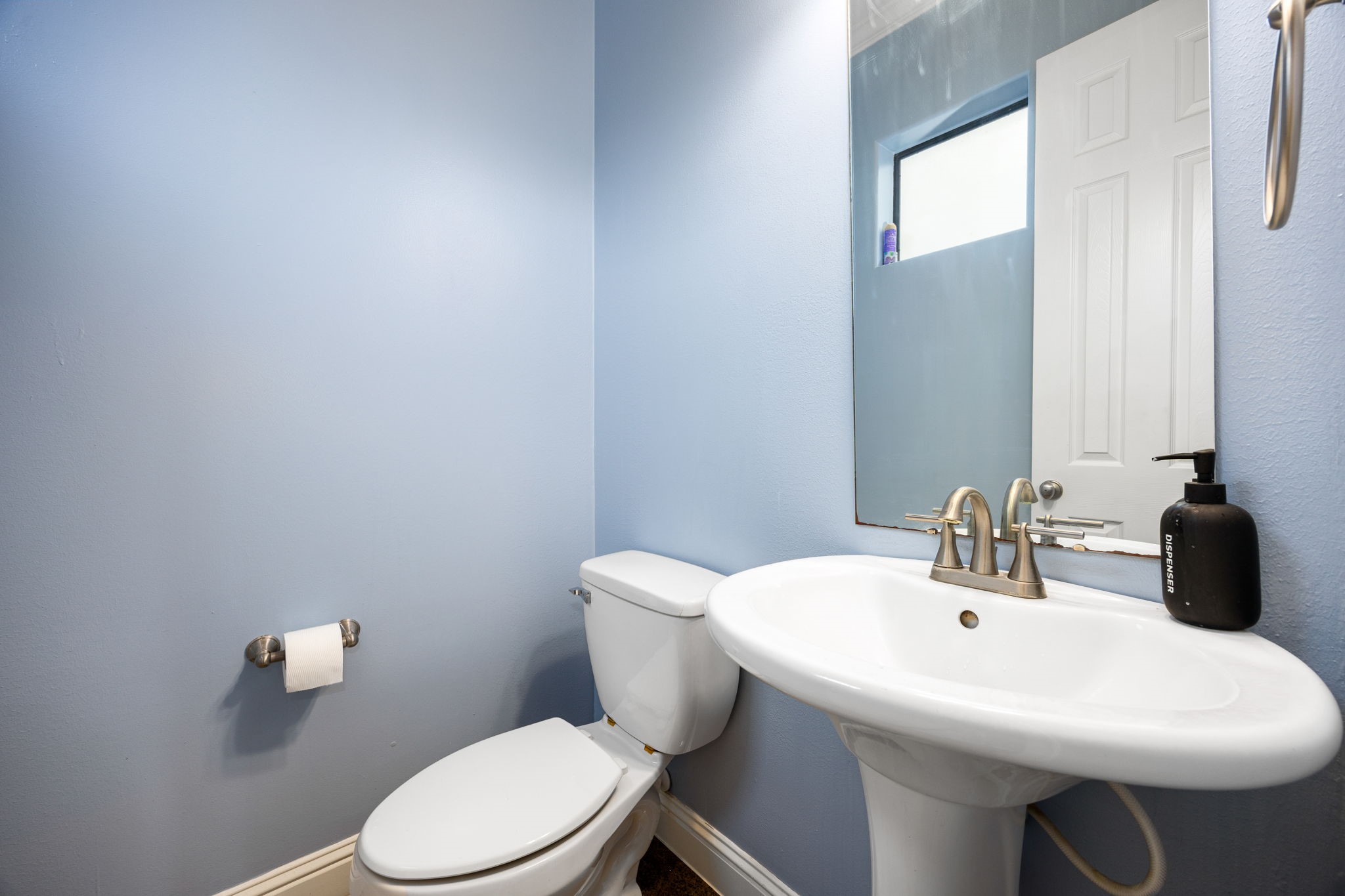 2611 Riverside Drive, Unit D Houston, TX 77004 - Photo 17 of 50 a bathroom with a sink a toilet and mirror