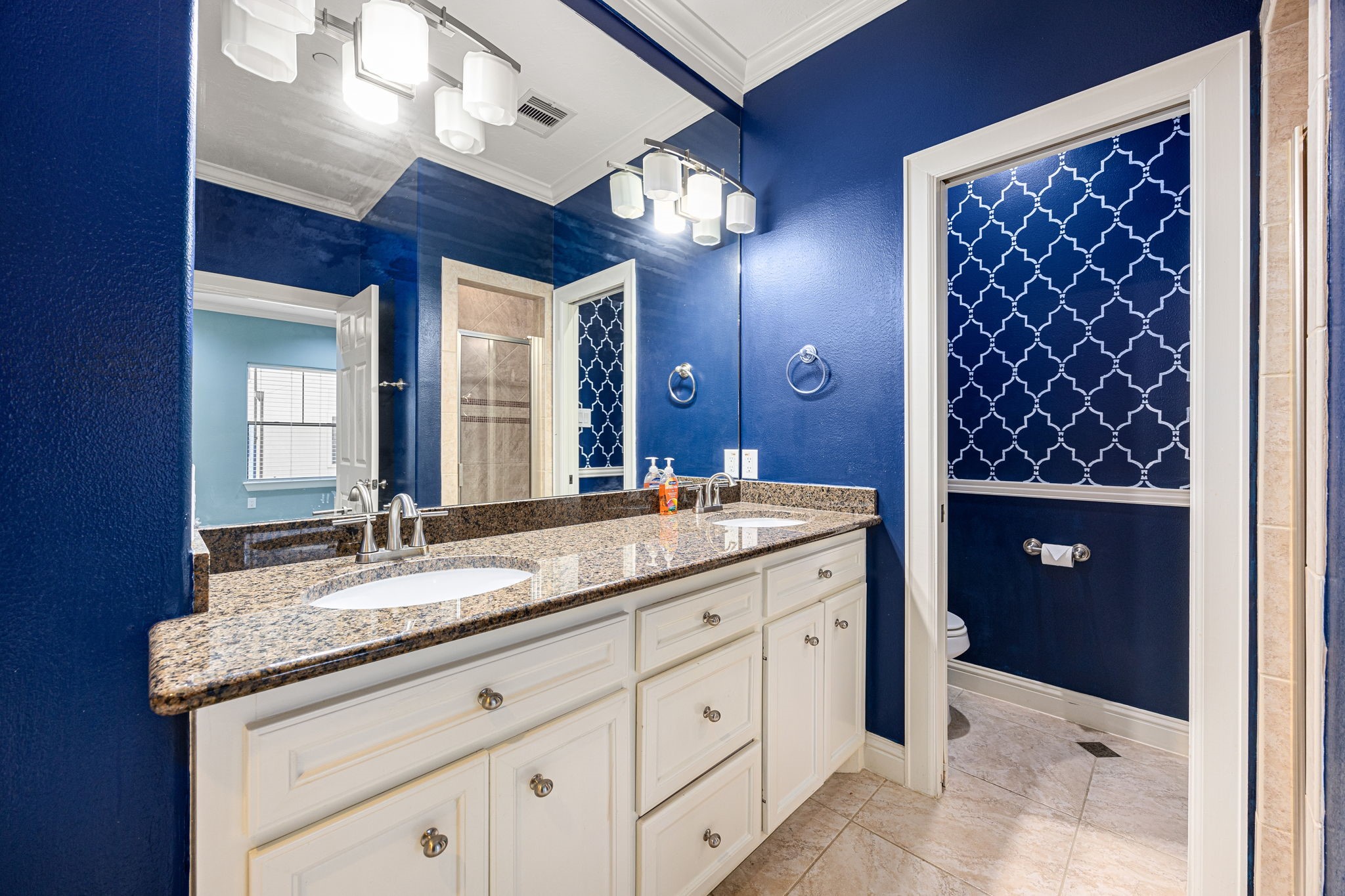 2611 Riverside Drive, Unit D Houston, TX 77004 - Photo 22 of 50 a bathroom with a granite countertop sink a large mirror and a shower
