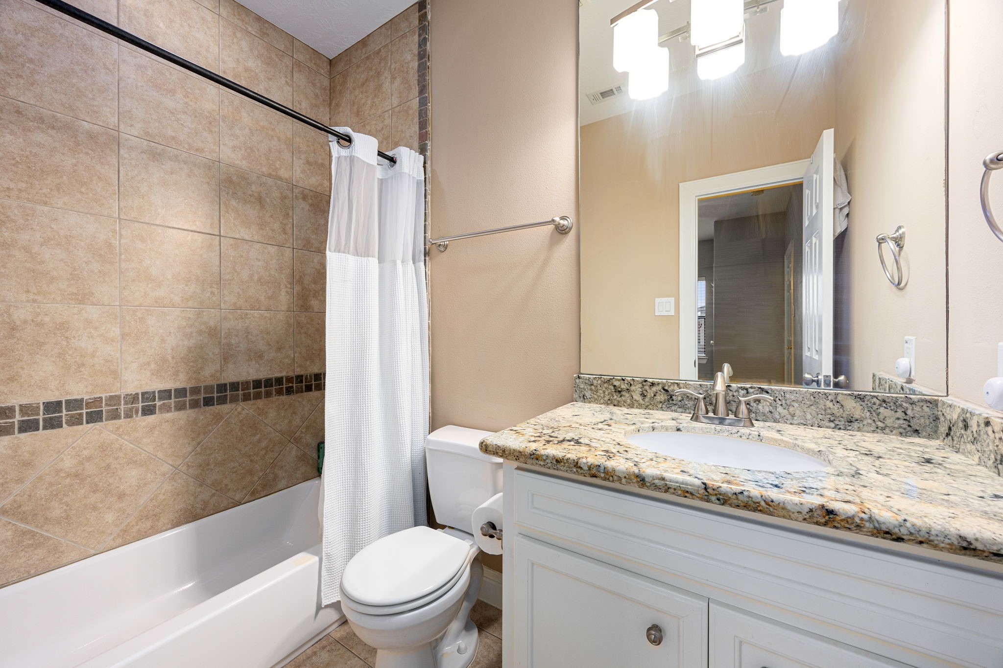 2611 Riverside Drive, Unit D Houston, TX 77004 - Photo 25 of 50 a bathroom with a granite countertop bathtub shower sink vanity and toilet