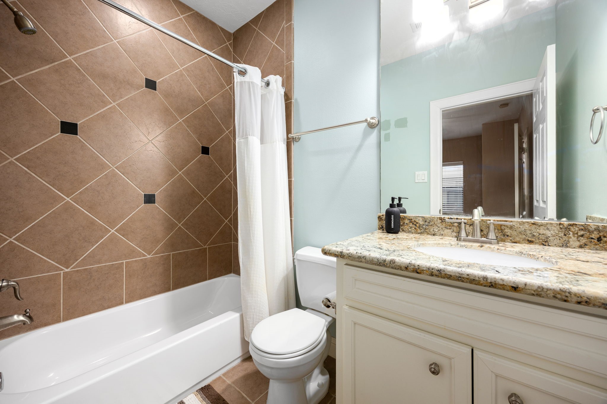 2611 Riverside Drive, Unit D Houston, TX 77004 - Photo 7 of 50 a bathroom with a granite countertop sink toilet and shower