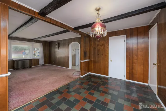 a view of a hallway with a chandelier and front door