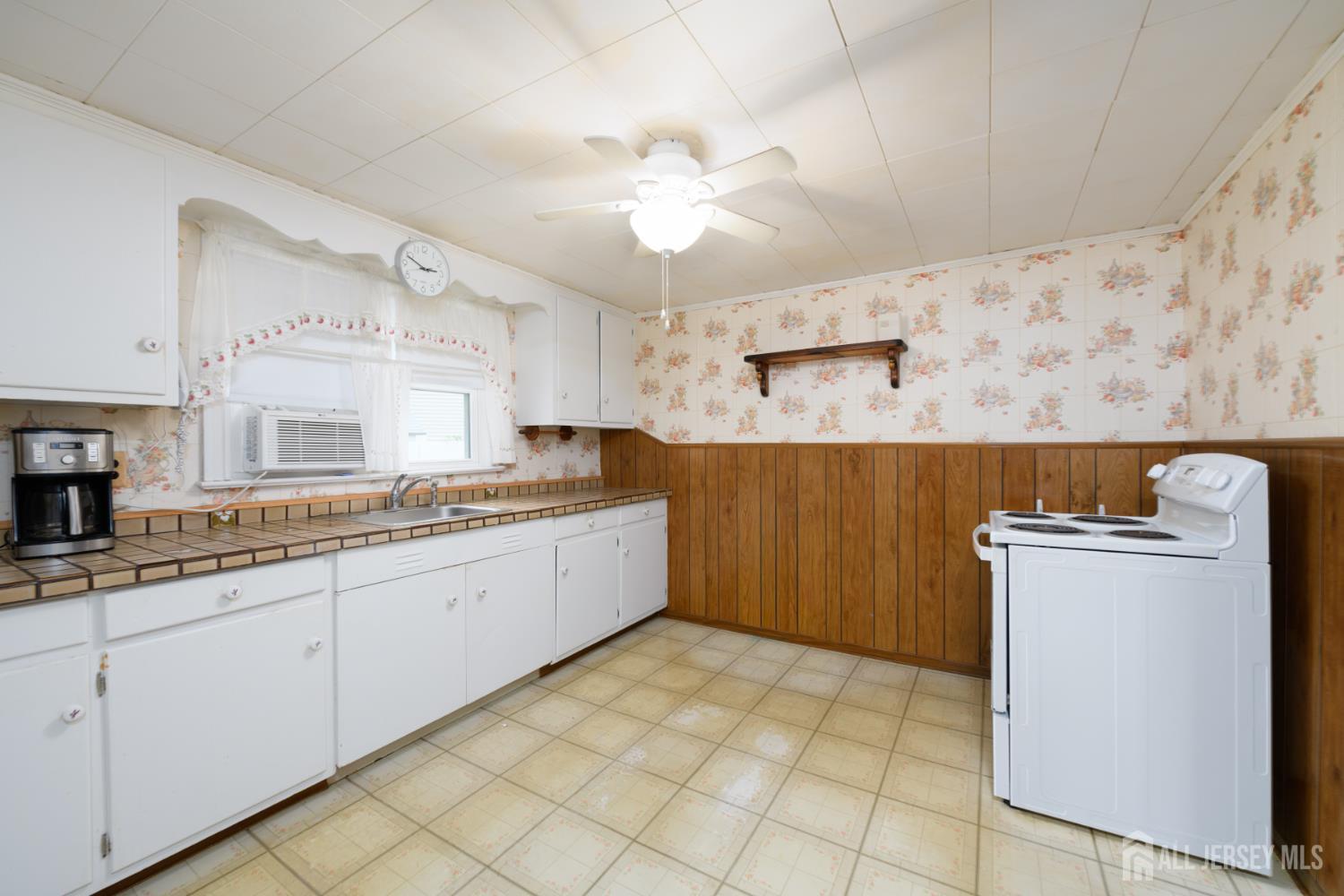 110 Sheppard Place Fords, NJ 08863 - Photo 8 of 34 a kitchen with cabinets and window