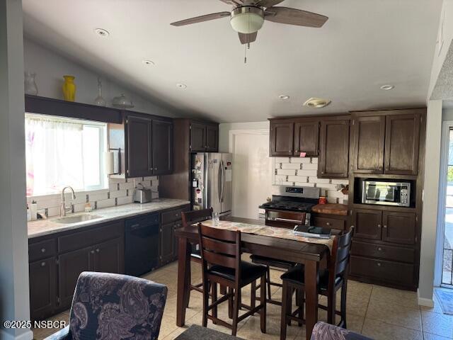 3590 Via Gala Lompoc, CA 93436 - Photo 6 of 17 a kitchen with stainless steel appliances kitchen island granite countertop a table chairs refrigerator and microwave