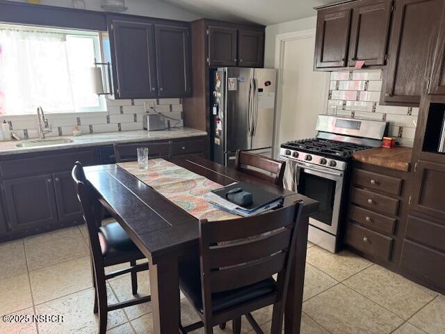 3590 Via Gala Lompoc, CA 93436 - Photo 7 of 17 a kitchen with stainless steel appliances granite countertop a stove a refrigerator a sink a dining table and chairs