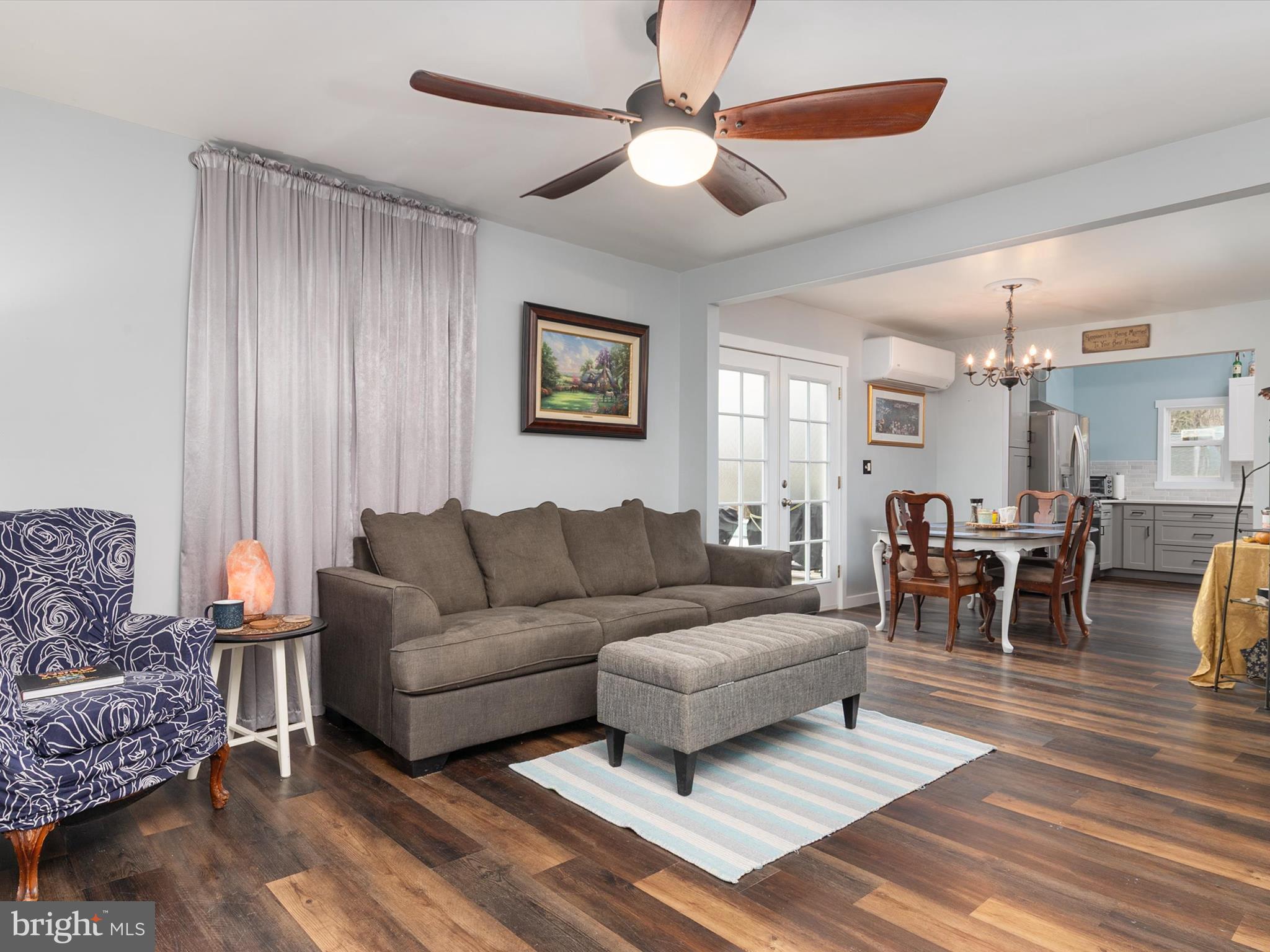 9 Lexington Road Harmans, MD 21077 - Photo 2 of 41 a living room with furniture a clock on wall and a window
