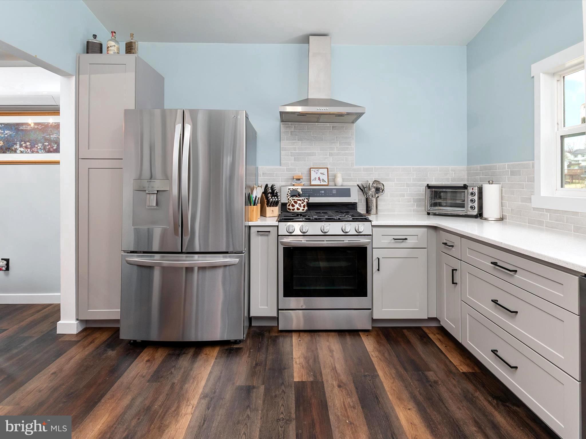9 Lexington Road Harmans, MD 21077 - Photo 9 of 41 a kitchen with a stove top oven and refrigerator
