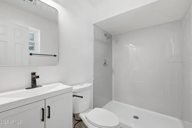 a living room with furniture and a dining table