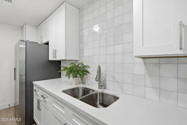a kitchen with a sink and refrigerator